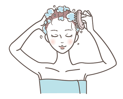 女性がヘッドブラシで頭を洗っているイラスト
